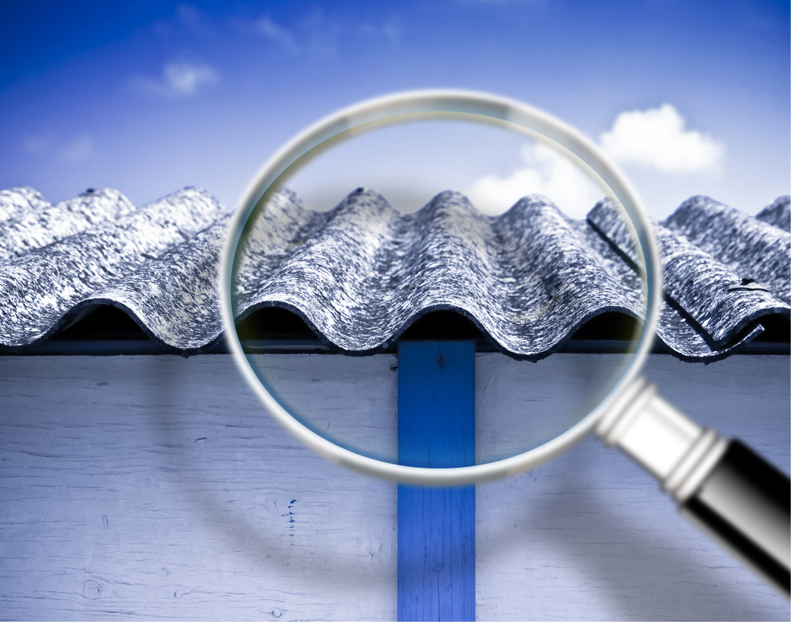 A magnifying glass is over the roof of a house.