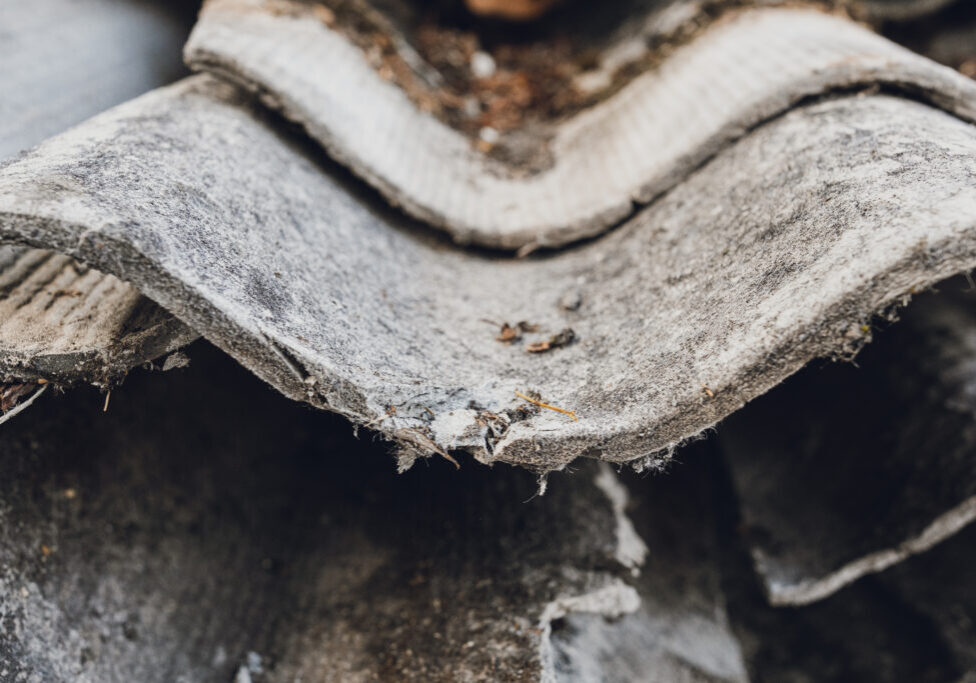 Old and very dangerous asbestos roof. Asbestos dust in the environment. Health problems.